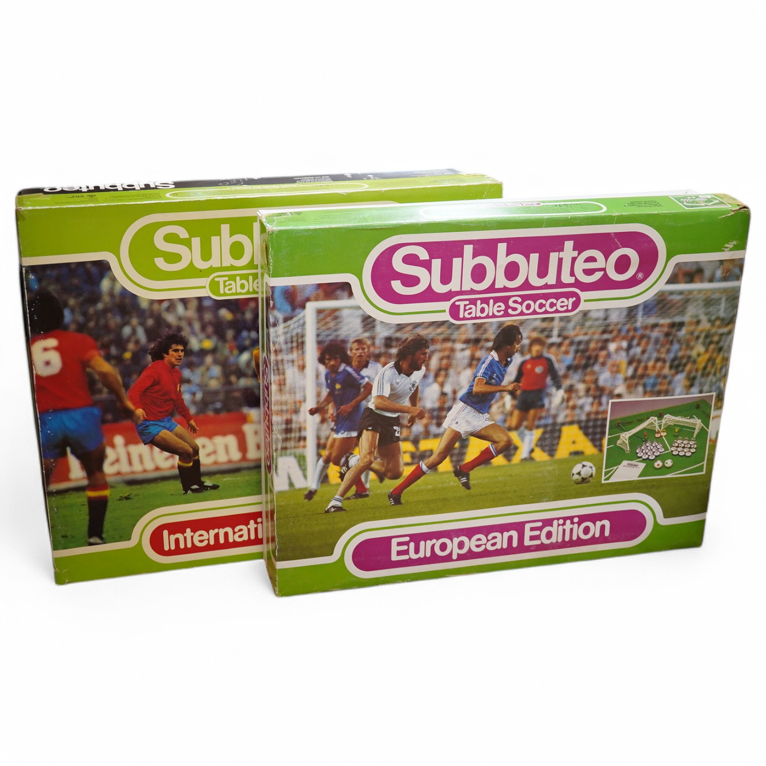 Two boxed Subbuteo table football sets; a European Edition, comprising of two teams, spectators and line side staff, pitch, etc. (some parts missing), and an International Edition, comprising of three teams, stadium ligh